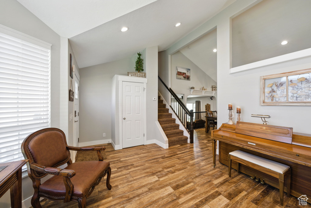 Sitting room featuring light wood-type flooring, recessed lighting, stairs, and baseboards
