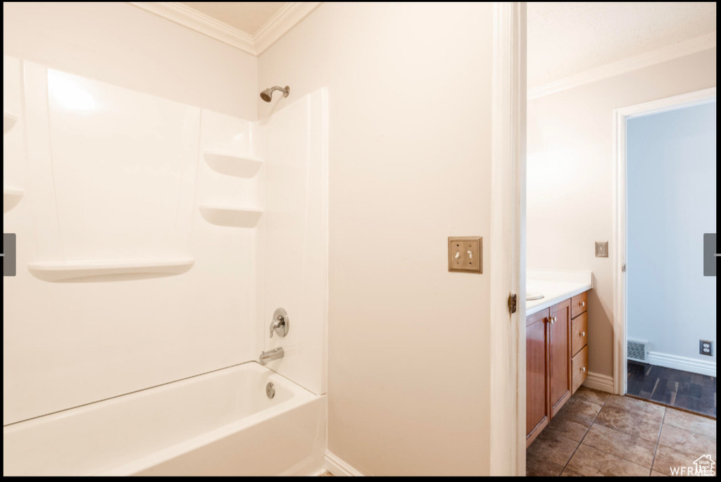 Full bathroom with crown molding, shower / tub combination, vanity, baseboards, and visible vents