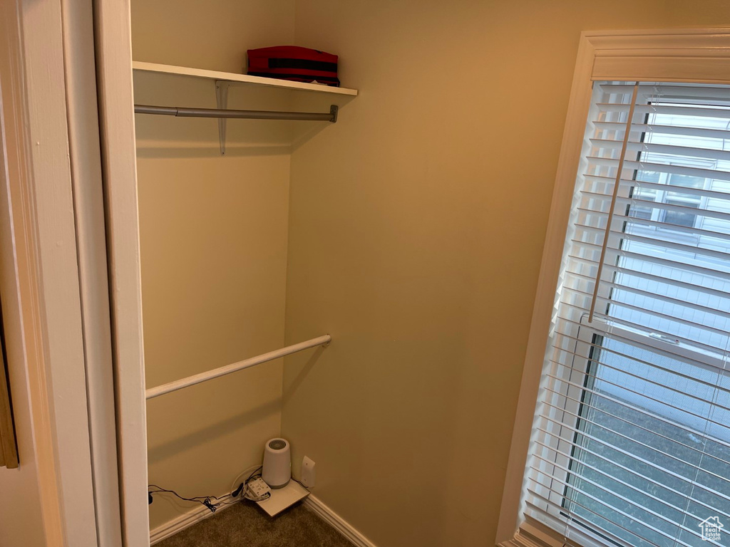 Interior space with carpet flooring and baseboards