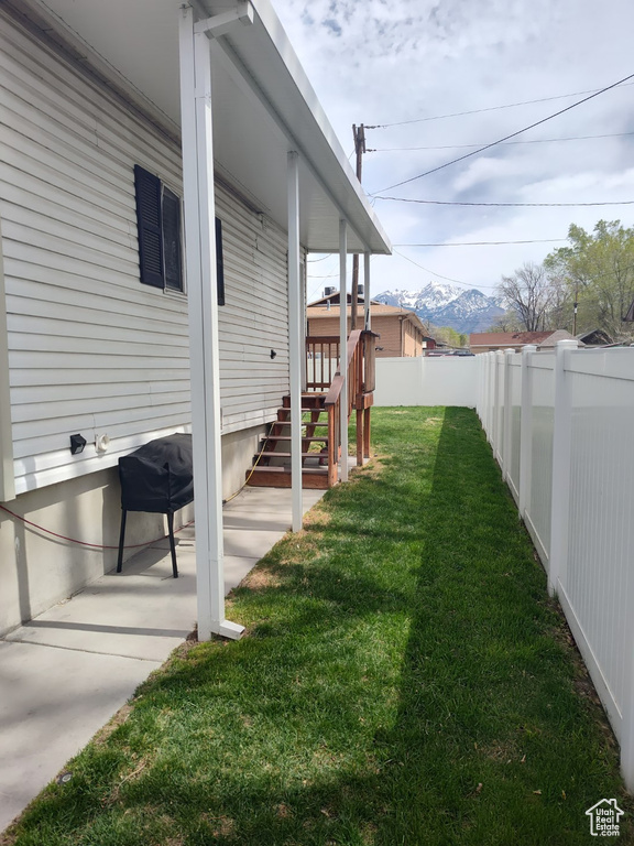 View of yard with a fenced backyard and a mountain view