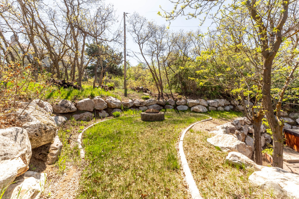 View of yard with an outdoor fire pit