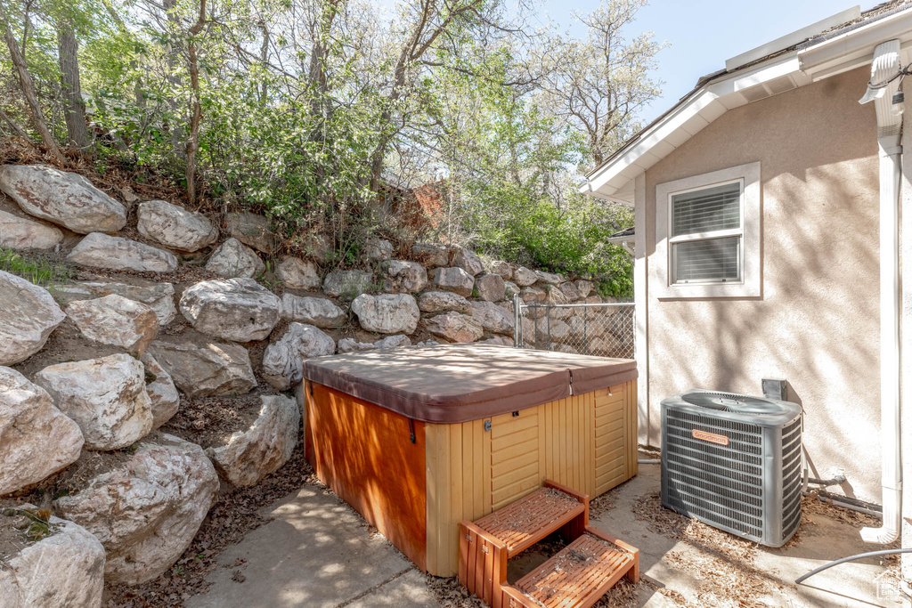 View of patio / terrace featuring a hot tub and cooling unit