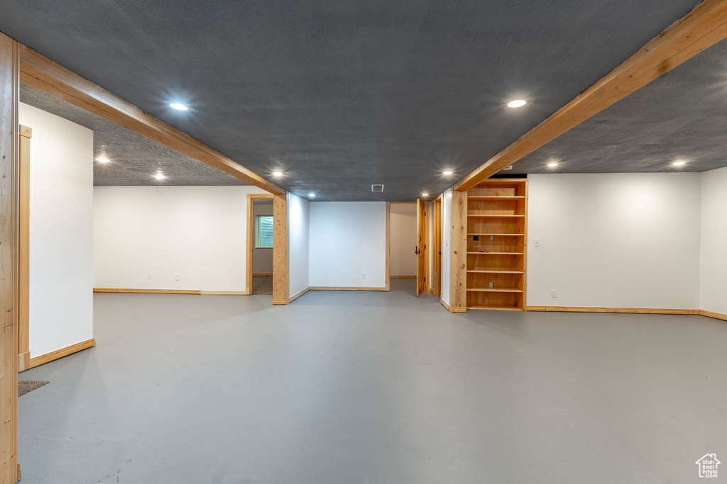 Finished below grade area featuring recessed lighting, baseboards, and built in features