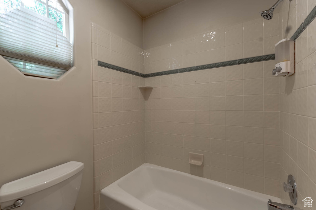 Full bathroom with toilet and tub / shower combination