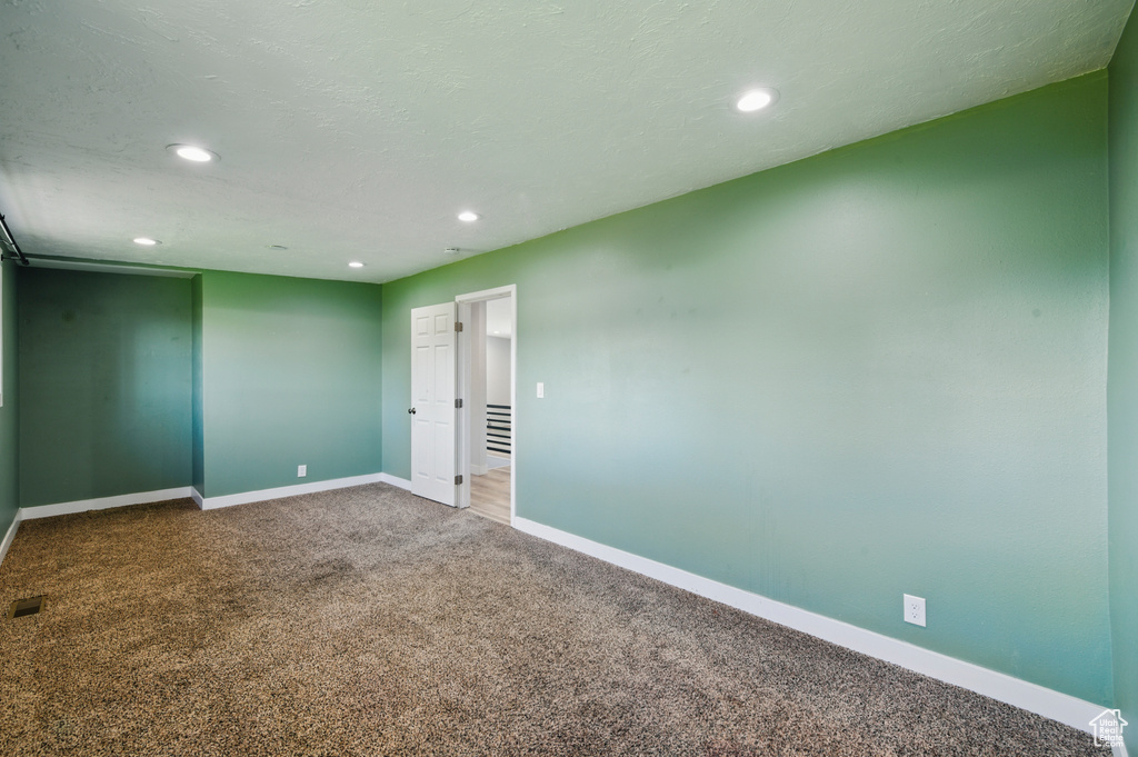 Spare room with carpet flooring, recessed lighting, and baseboards