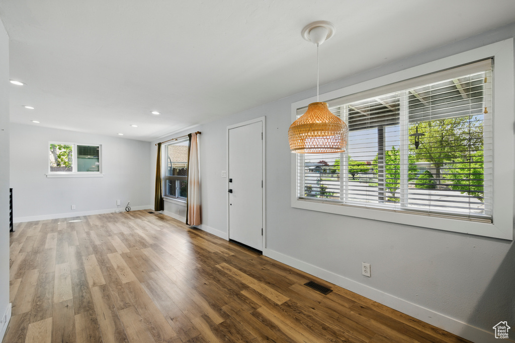 Interior space with baseboards, wood finished floors, and visible vents