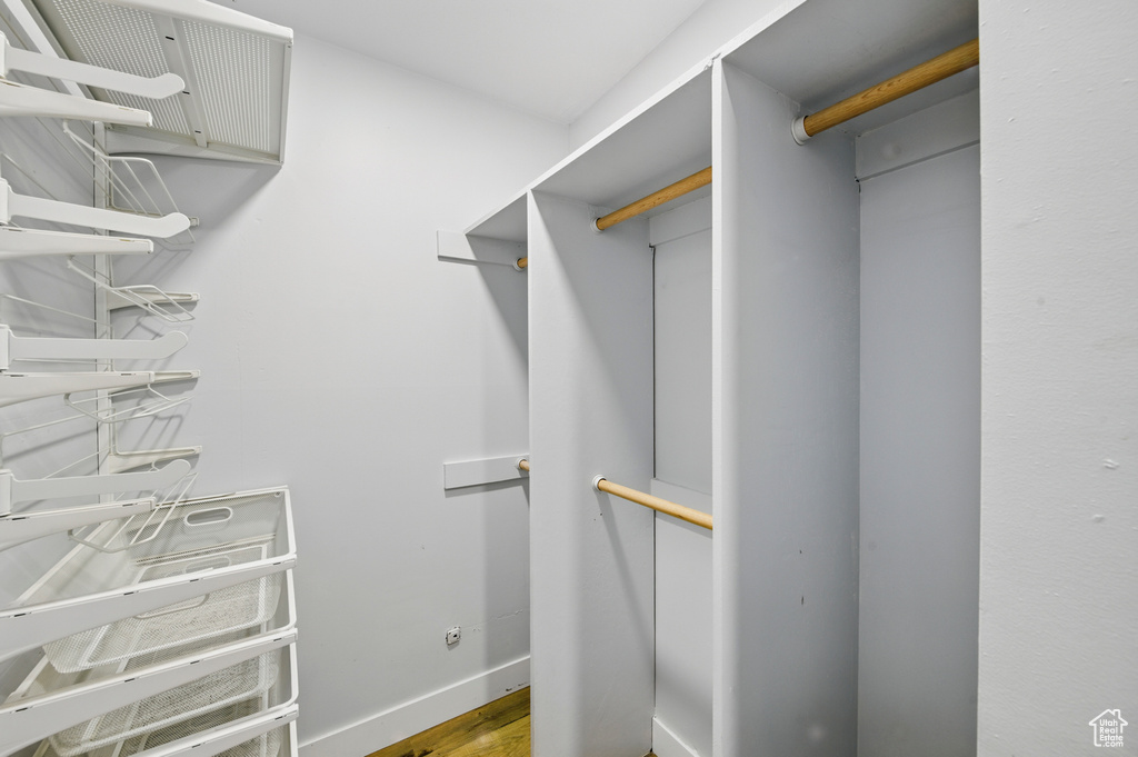 Walk in closet featuring wood finished floors