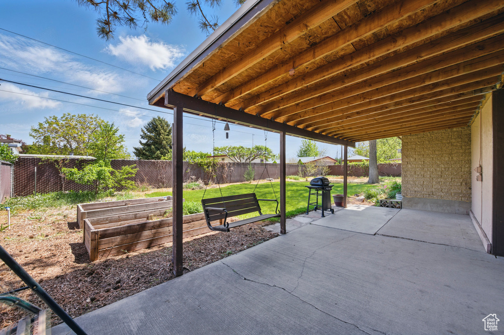 View of patio / terrace featuring a fenced backyard and a vegetable garden