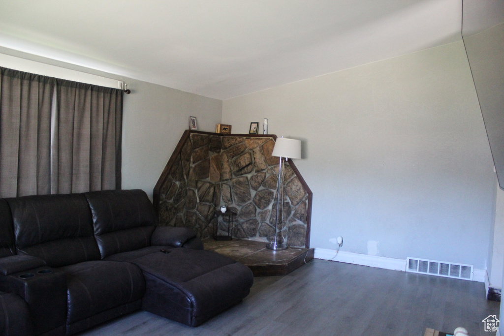 Living room featuring baseboards, wood finished floors, and visible vents