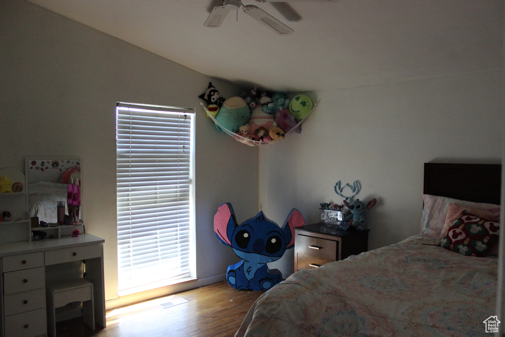 Bedroom with a ceiling fan and wood finished floors