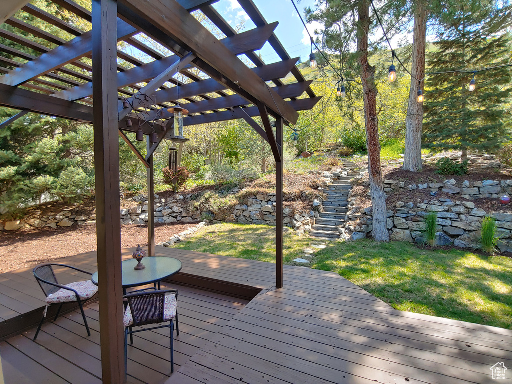 Wooden terrace with a lawn and a pergola