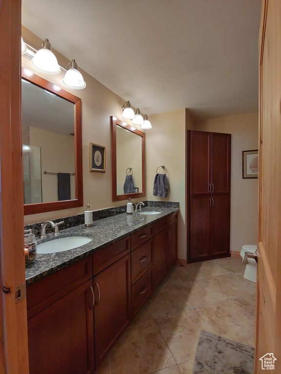 Bathroom featuring double vanity and a sink
