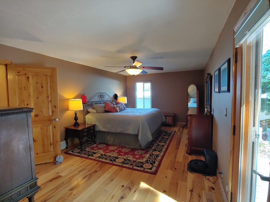 Bedroom with baseboards, ceiling fan, and wood finished floors