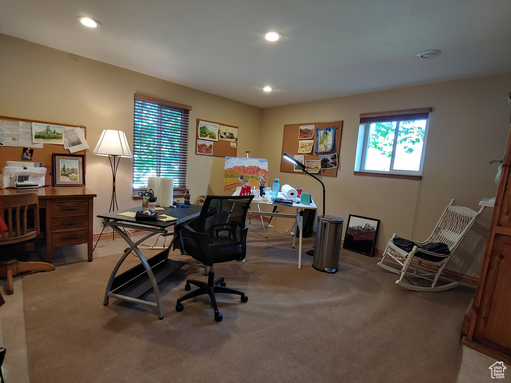 Office with light carpet and recessed lighting