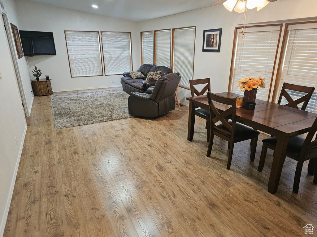 Dining area with baseboards, ceiling fan, recessed lighting, and light wood-style flooring