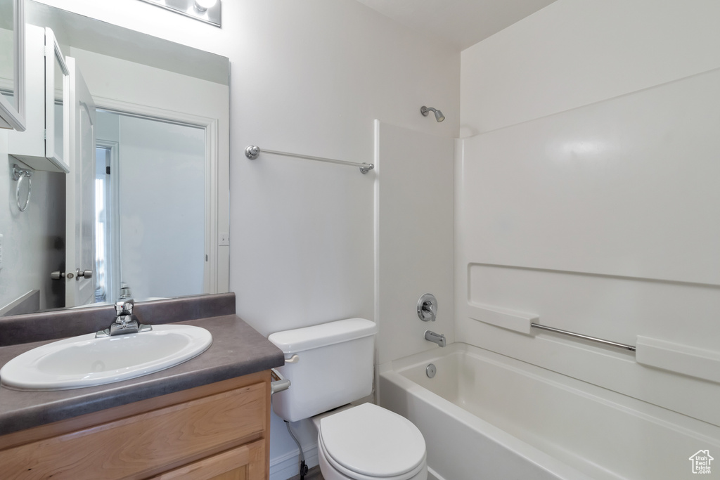 Full bathroom with shower / bathtub combination, toilet, and vanity