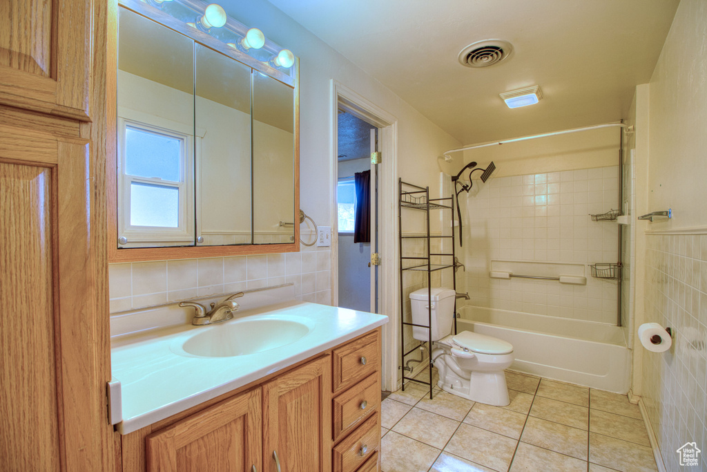 Full bathroom with visible vents, shower / washtub combination, tile patterned floors, vanity, and toilet