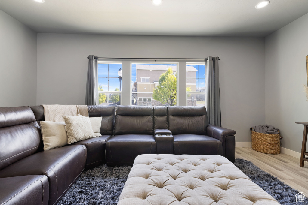 Living area with recessed lighting, plenty of natural light, and wood finished floors