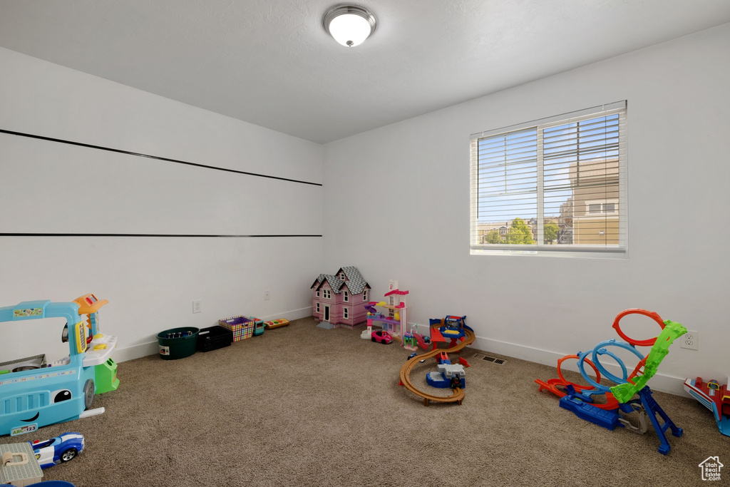 Game room featuring carpet floors, baseboards, and visible vents