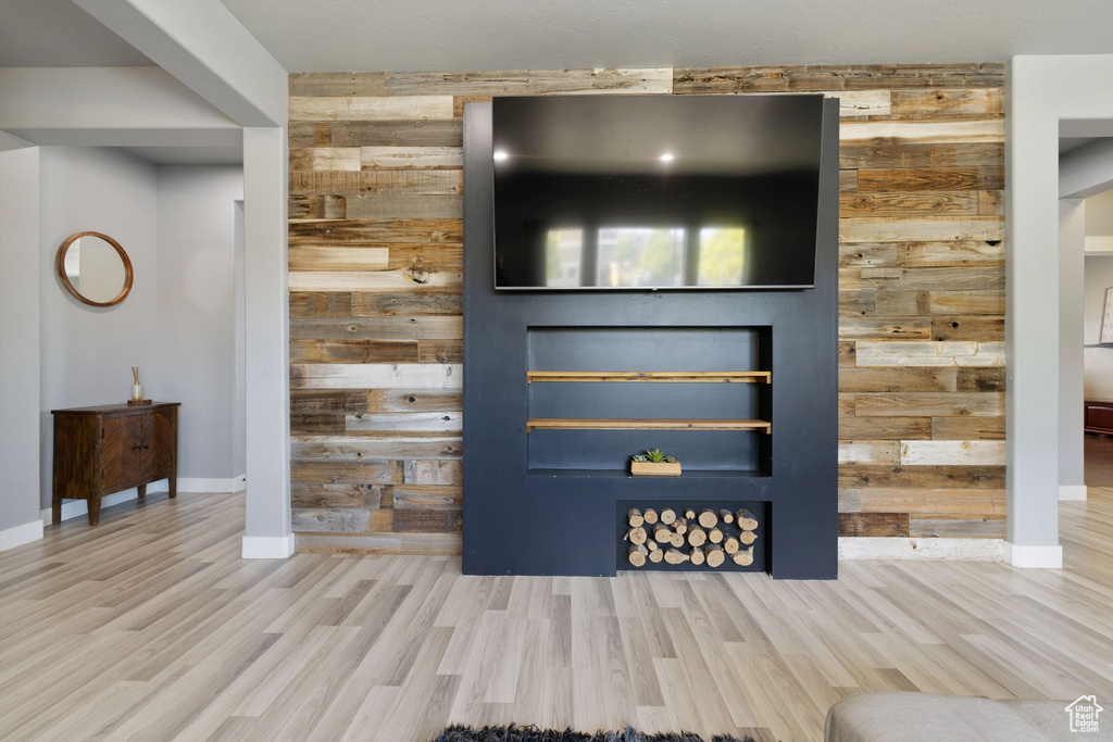 Interior space featuring baseboards, wood walls, and wood finished floors