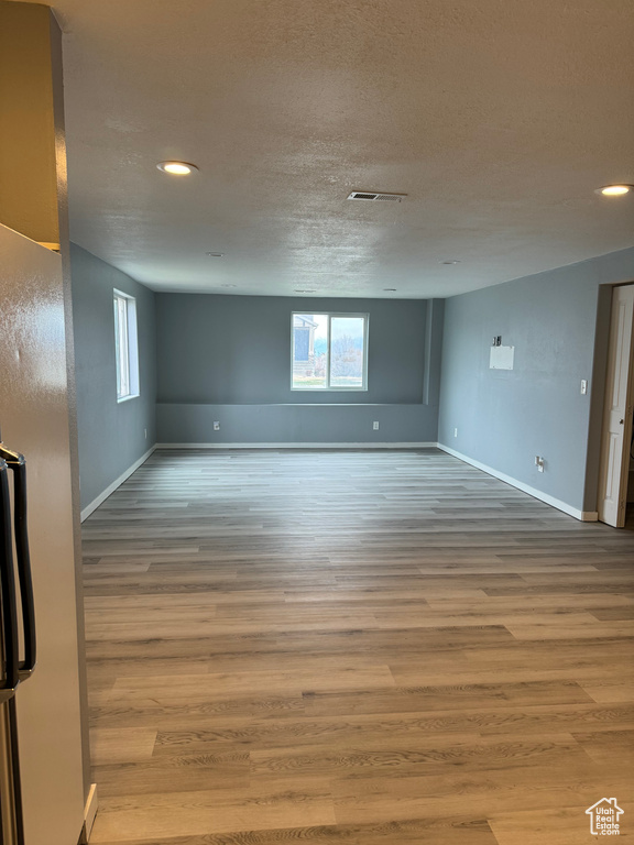 Unfurnished room featuring recessed lighting, baseboards, and wood finished floors