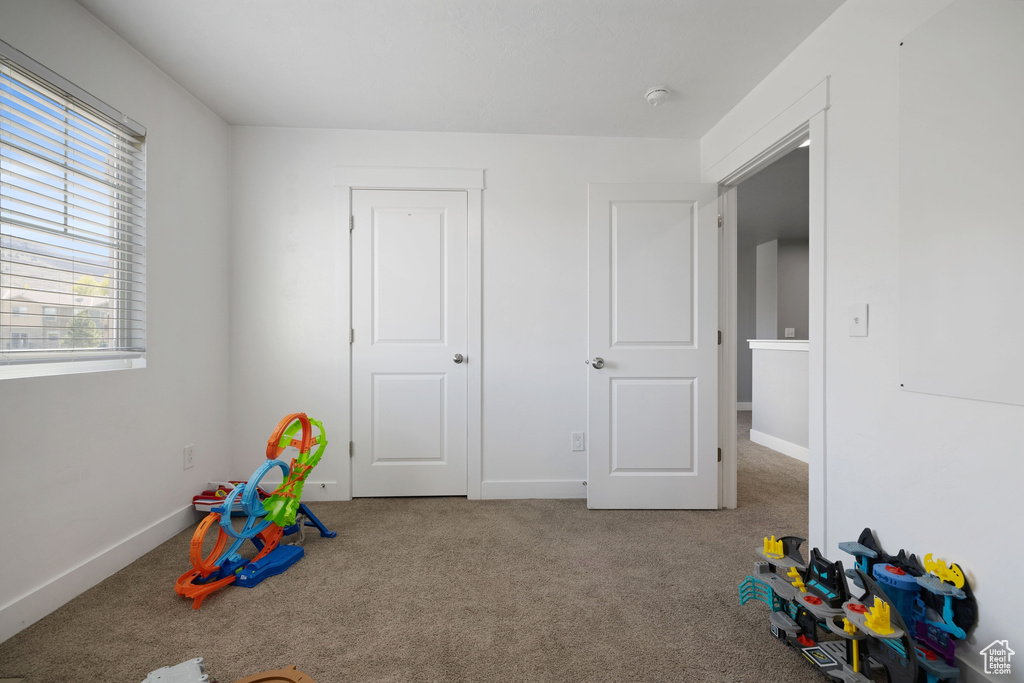 Game room featuring carpet floors and baseboards