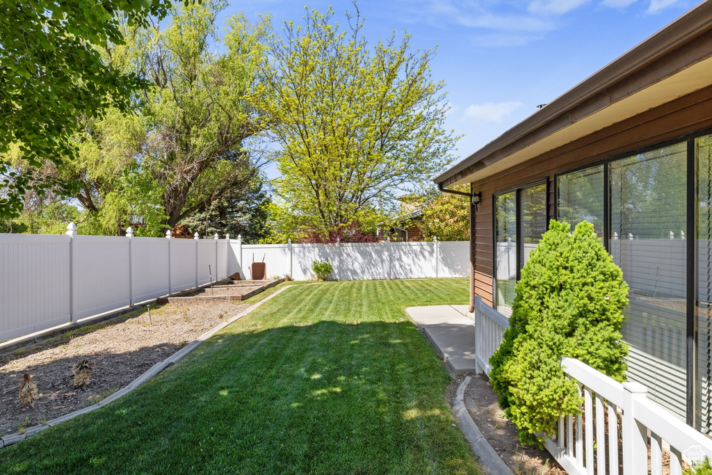 View of yard featuring a fenced backyard and a vegetable garden