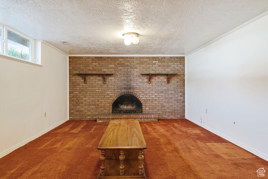 Unfurnished living room with carpet flooring, baseboards, and a brick fireplace