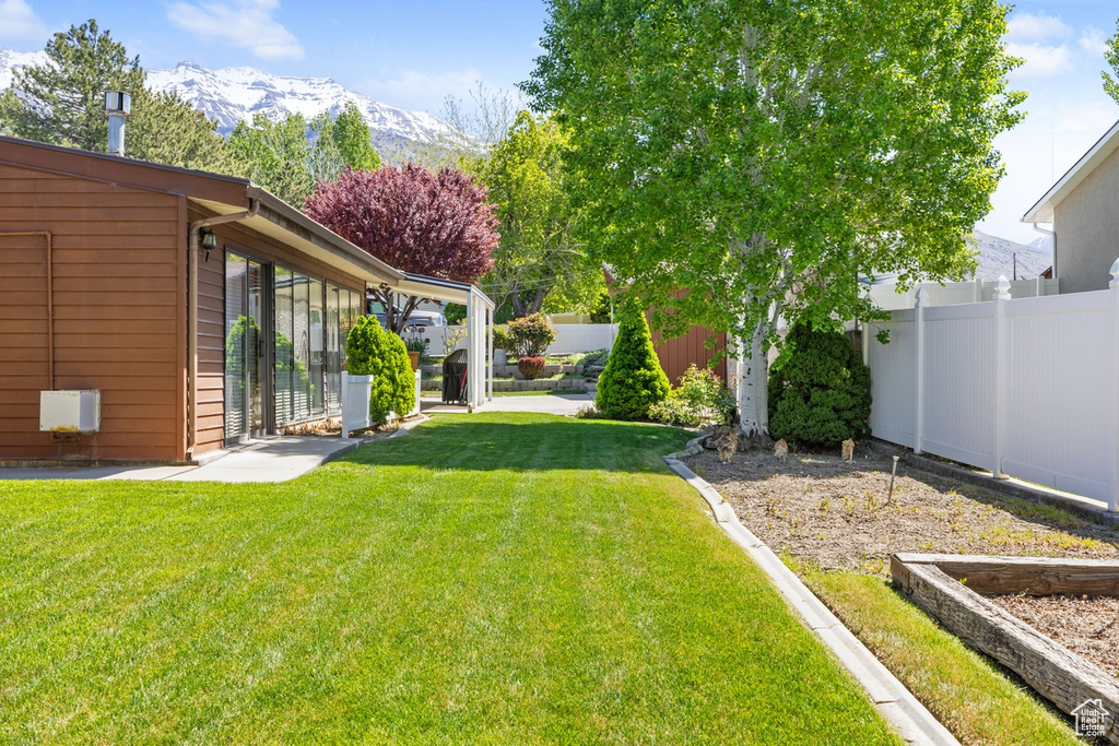 View of yard featuring fence and a mountain view