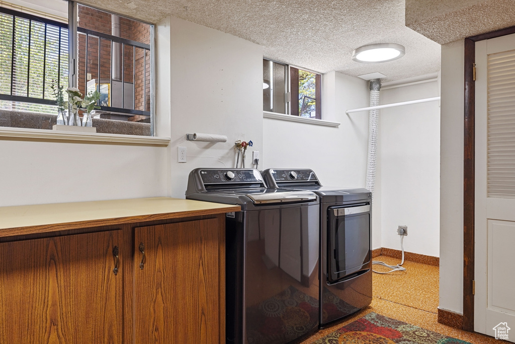Laundry area with washer and dryer, laundry area, and baseboards