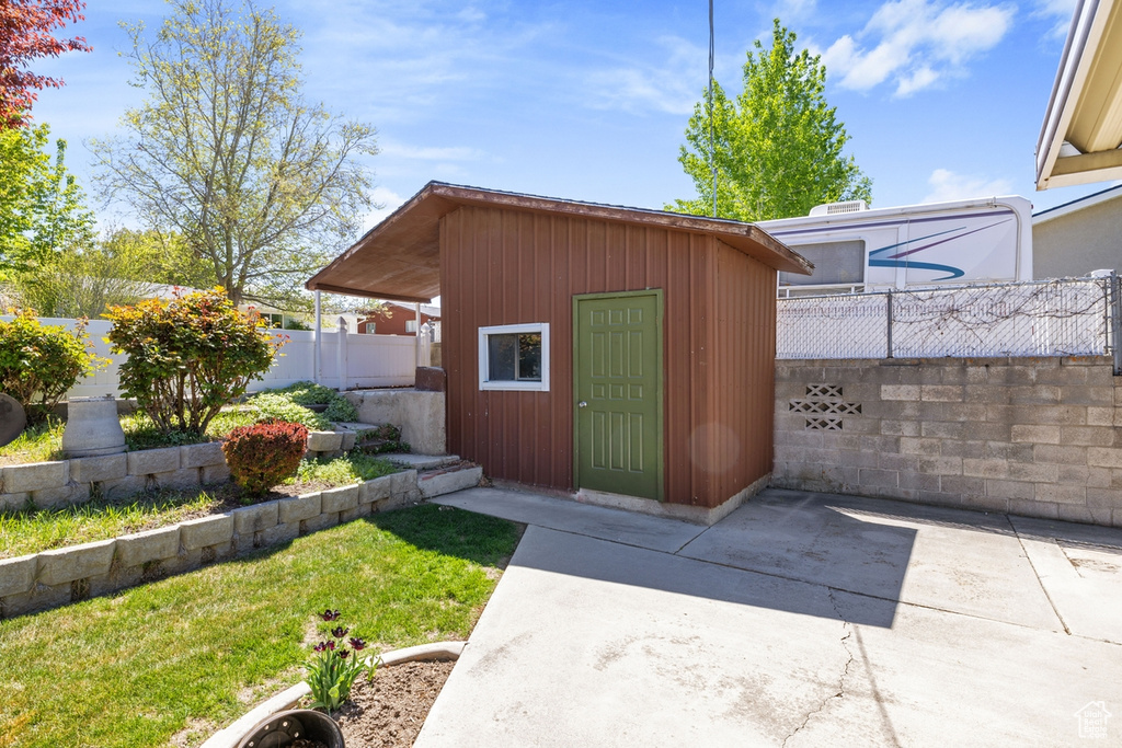 View of outbuilding with a fenced backyard and an outbuilding