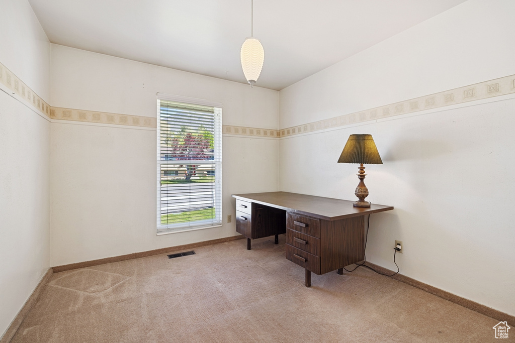 Carpeted home office featuring baseboards, visible vents, and a healthy amount of sunlight