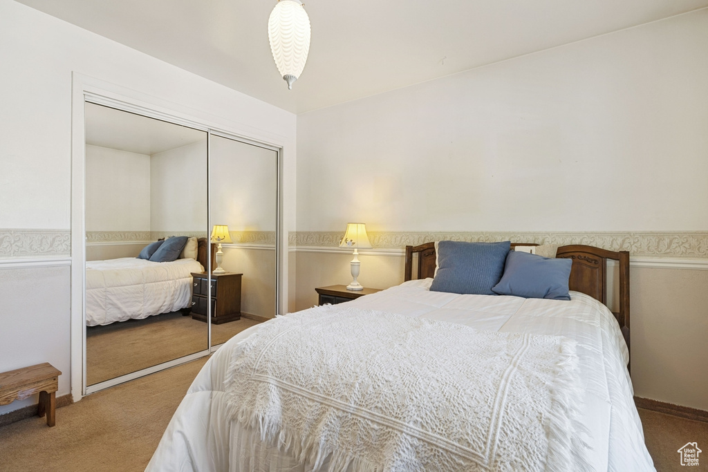 Carpeted bedroom with a closet