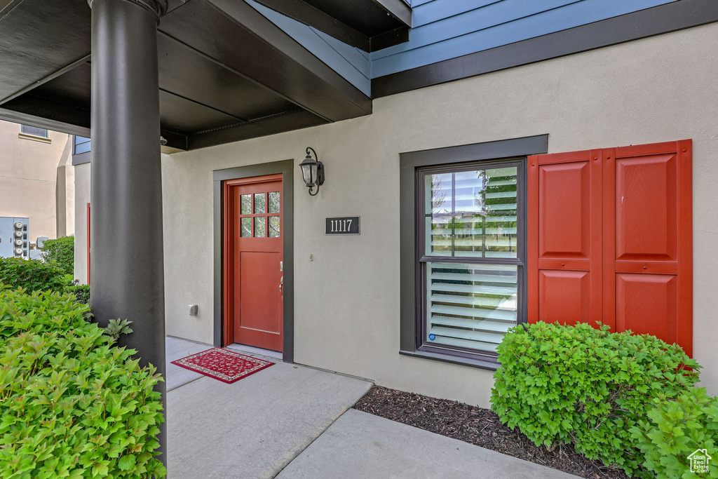 Entrance to property with stucco siding