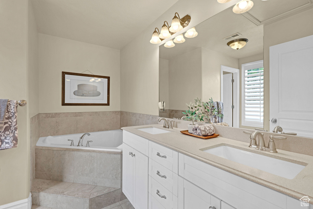Full bath featuring visible vents, a sink, and a bath