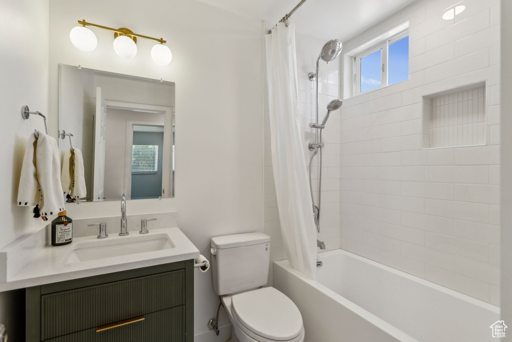 Full bath with vanity, shower / bath combination with curtain, and toilet