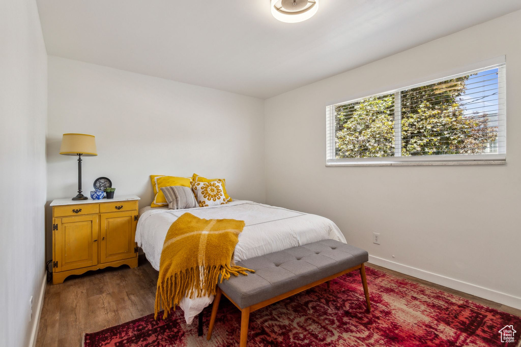 Bedroom with baseboards and light wood-type flooring