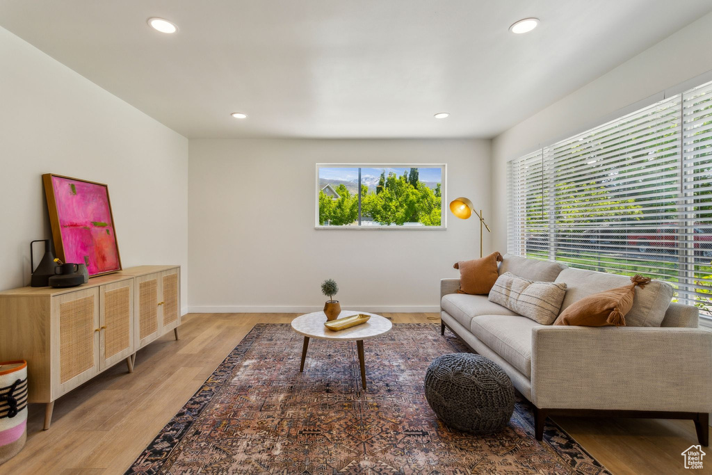 Living room featuring recessed lighting, baseboards, a wealth of natural light, and light wood finished floors