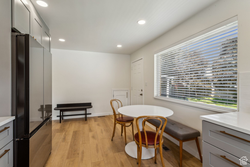 Dining room with recessed lighting and light wood finished floors