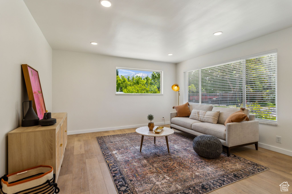Living room featuring recessed lighting, a healthy amount of sunlight, and light wood finished floors