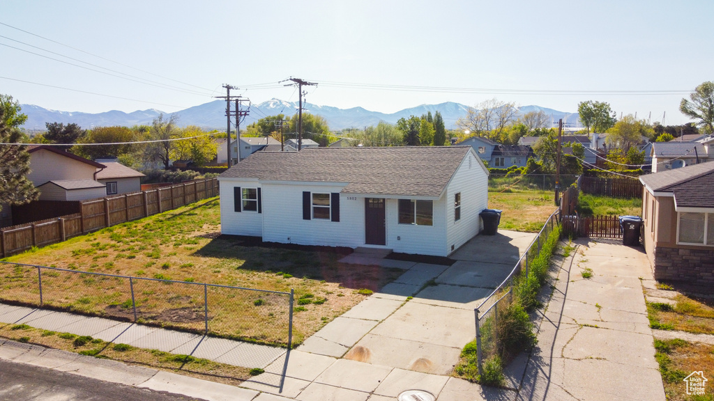 Bungalow-style house featuring fence private yard, roof with shingles, and a mountain view