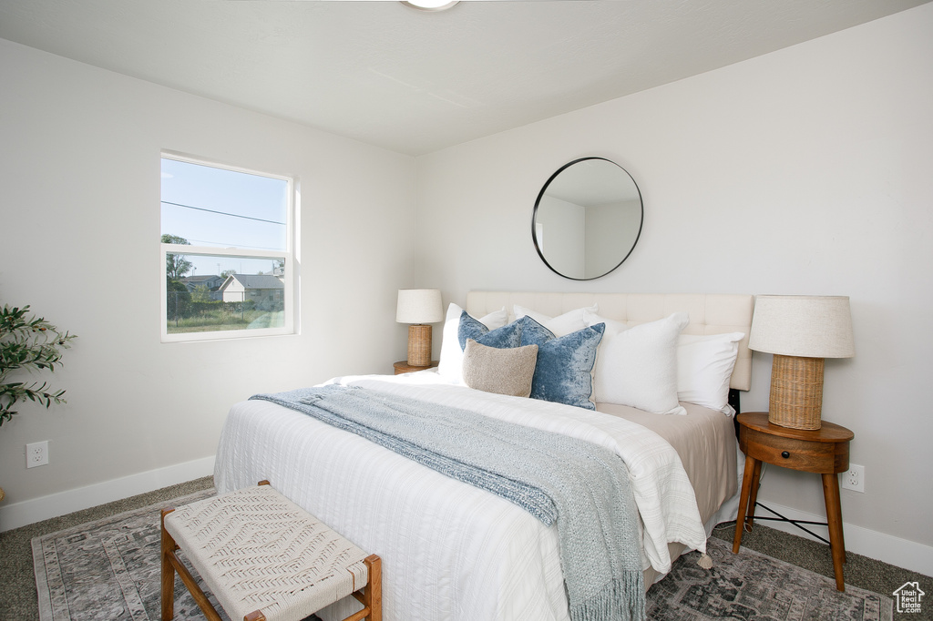 Bedroom featuring baseboards and carpet