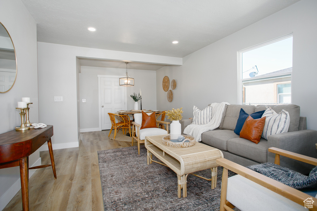 Living area with recessed lighting, baseboards, and light wood-type flooring
