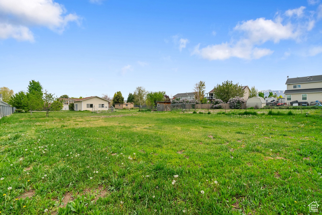 View of yard with fence and a residential view