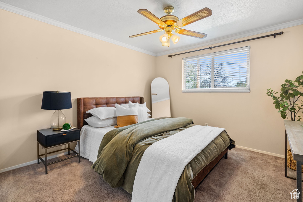 Bedroom with carpet flooring, baseboards, ornamental molding, and ceiling fan