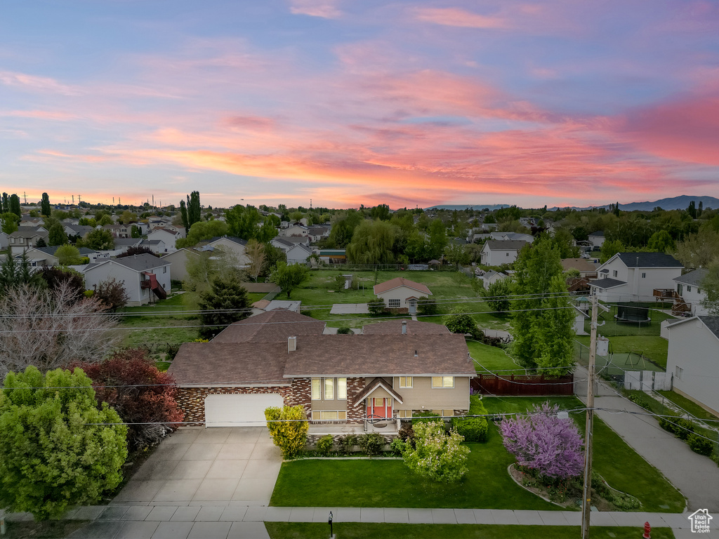Aerial view at dusk featuring a residential view