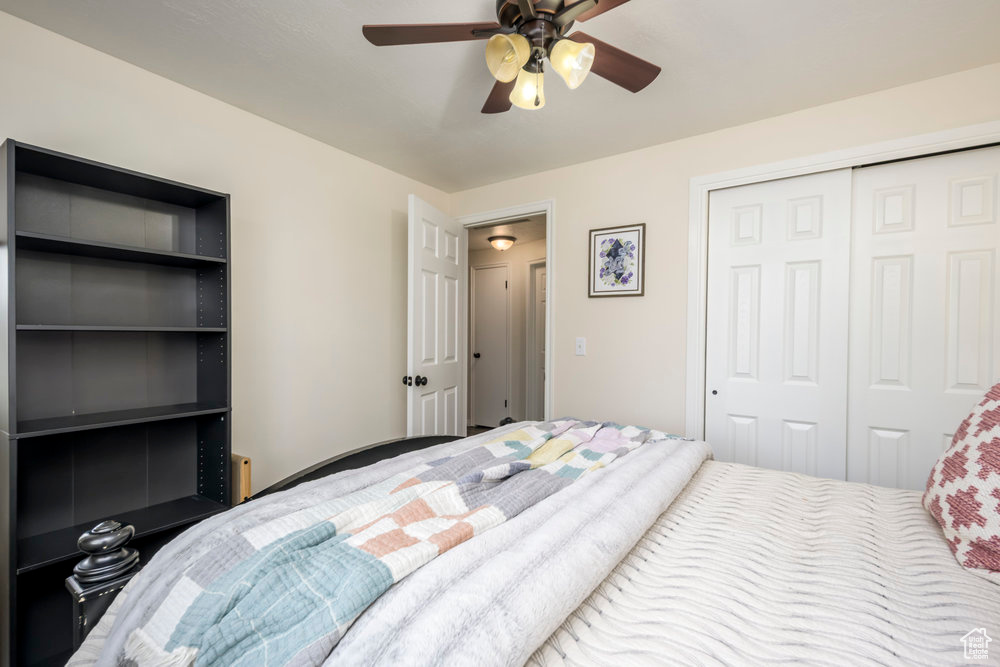 Bedroom with a ceiling fan and a closet