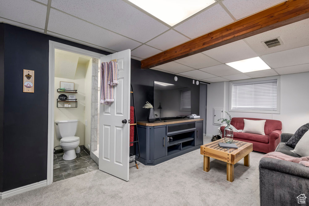 Carpeted living room with visible vents and a paneled ceiling