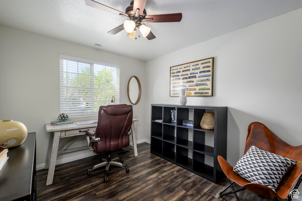 Office featuring a ceiling fan, baseboards, and wood finished floors