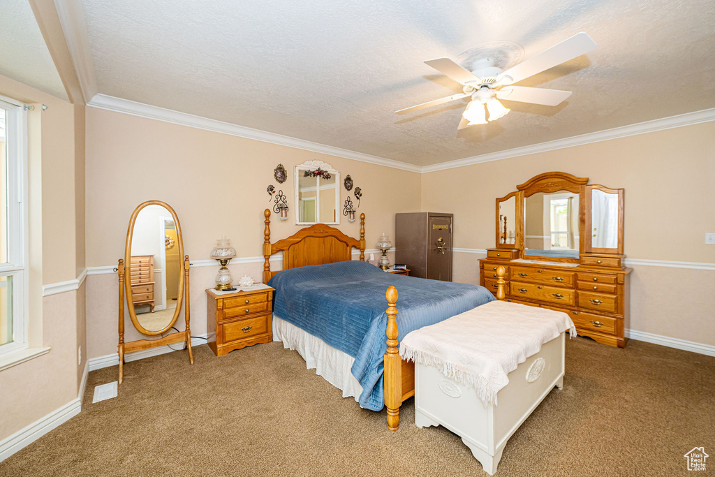 Carpeted bedroom with crown molding and baseboards